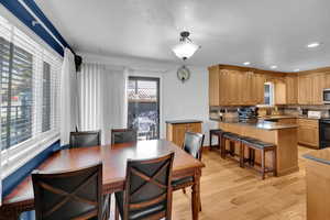 Dining space featuring recessed lighting, a textured ceiling, and light wood finished floors