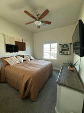 Bedroom with baseboards, visible vents, carpet, and ceiling fan
