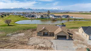 Drone / aerial view with a water and mountain view and a residential view