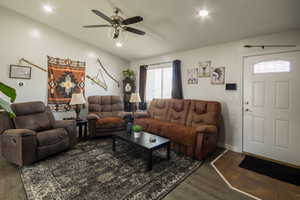 Living room featuring ceiling fan, a wealth of natural light, wood finished floors, and recessed lighting