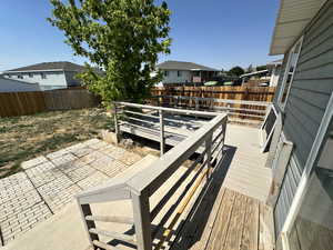 Wooden terrace featuring a fenced backyard, a patio area, and a residential view