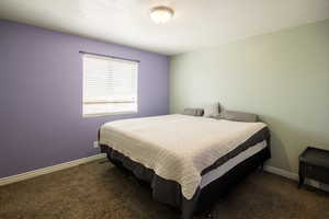 Carpeted bedroom with baseboards