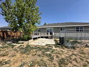 Rear view of property with a deck and a patio area
