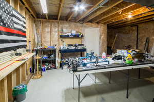 Unfinished below grade area featuring a workshop area