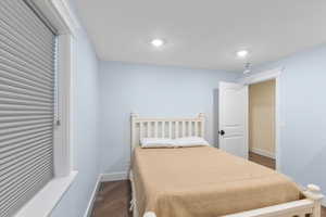 Bedroom featuring recessed lighting, wood finished floors, and baseboards