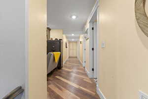 Corridor with baseboards and wood finished floors