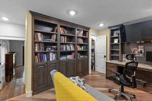 Office space featuring wood finished floors and visible vents