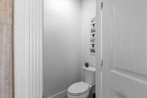 Bathroom featuring toilet and baseboards