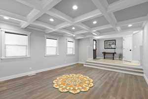 Unfurnished living room with wood finished floors, baseboards, and recessed lighting