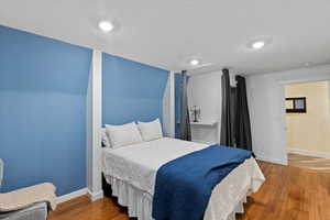 Bedroom featuring baseboards and wood finished floors