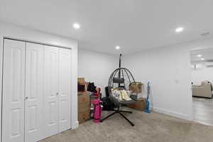 Playroom with carpet, baseboards, an AC wall unit, and recessed lighting