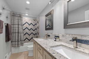 Full bathroom with visible vents, a sink, and toilet