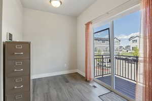 Interior space with baseboards, wood finished floors, and visible vents