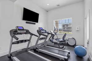 Workout area with visible vents, baseboards, and recessed lighting