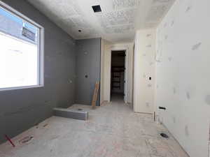 Owner's bath featuring a walk-in closet