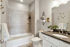 Full bathroom with shower / bath combination, toilet, and vanity