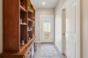 Mudroom with light LVP wood flooring, and recessed lighting