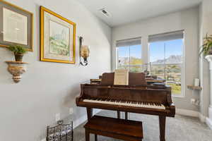 North end of living room - could be sitting area or piano area with mountain view, carpet floors, and visible vents