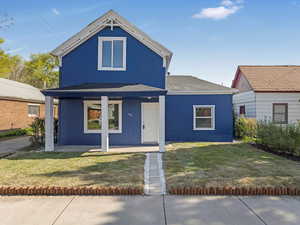 View of front of home with a front lawn and a porch
