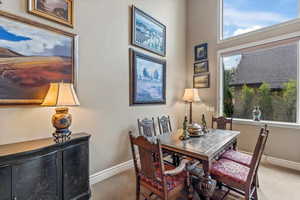 Carpeted dining area with baseboards