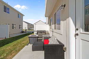 View of patio with fence, a grill, a residential view, and central AC unit