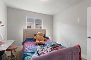 Carpeted bedroom with baseboards