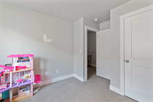 Rec room with carpet floors and baseboards