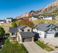 View of front of house with a mountain view, a residential view, and concrete driveway