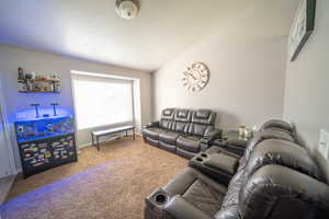 Carpeted living area featuring baseboards