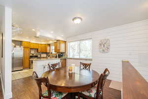 Dining area with recessed lighting, a textured ceiling, and light wood-type flooring