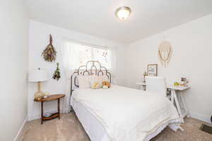 Carpeted bedroom featuring baseboards