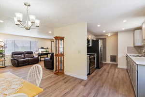 View from garage door to kitchen, dining and living room areas.