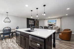 Kitchen featuring light countertops, light wood-style flooring, and a sink