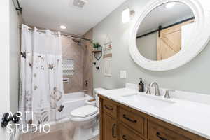 Bathroom with shower / bath combination with curtain, visible vents, vanity, and toilet