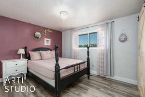 Bedroom featuring light wood-type flooring and baseboards