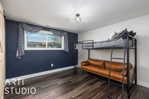 Bedroom featuring wood finished floors, visible vents, and baseboards