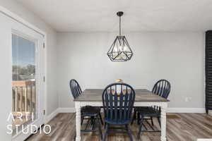 Dining area with an inviting chandelier, wood finished floors, and baseboards