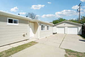 Ranch-style house featuring an outbuilding and a garage