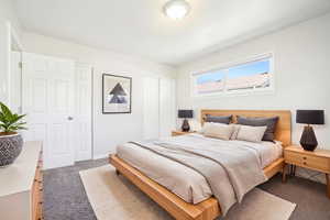Bedroom featuring dark carpet and two closets