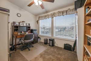 Office featuring lofted ceiling, a ceiling fan, and carpet flooring