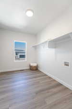 Walk in closet with wood finished floors