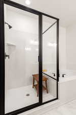 Full bath featuring a shower stall and a bath
