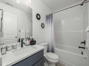 Full bathroom featuring shower / bath combo, vanity, and toilet