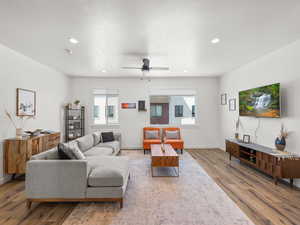 Living area featuring recessed lighting, high ceilings, LVP wood finished floors, and  lots of sunlight