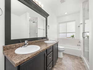 Bathroom with a sink, visible vents, and a stall shower