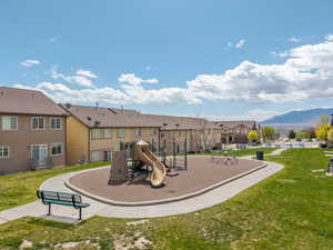 Community playground featuring a lawn, a mountain view, and a residential view
