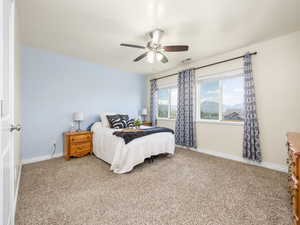 Bedroom featuring baseboards, a ceiling fan, carpet flooring, and visible vents
