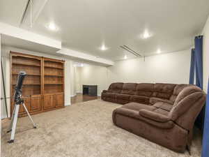 Living room with baseboards, carpet flooring, and recessed lighting