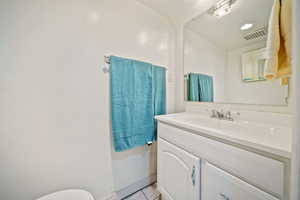 Bathroom with vanity, tile patterned floors, and visible vents