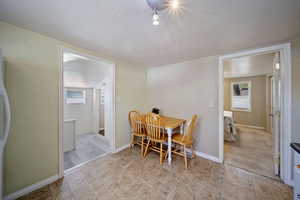 Dining room featuring baseboards and stone finish floor